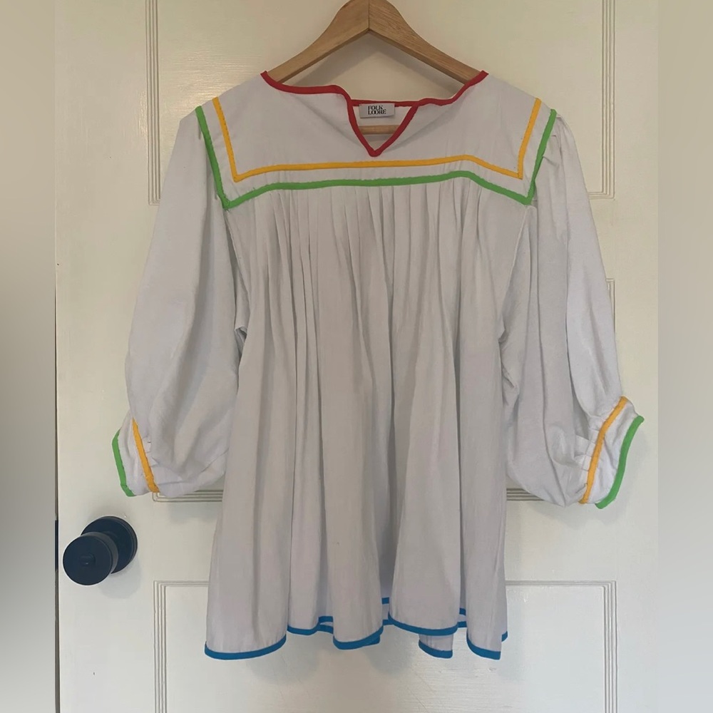 Beautiful white cotton blouse with color trim. Size free. New without tags.